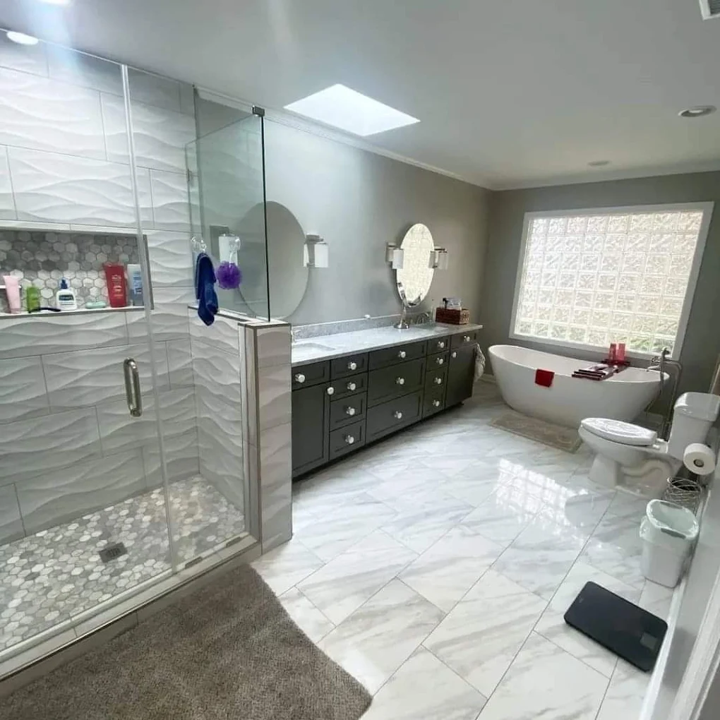 Spotless guest bathroom with glass shower and freestanding tub, professionally staged for an Airbnb turnover in Savannah, GA